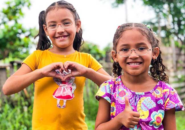 two happy girls from Colombia benefit from GoodVision Glasses
